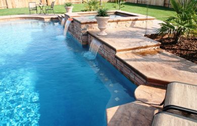 Total poolscapes near you, raised spa with spillway and dual cascade flowing into fiberglass pool