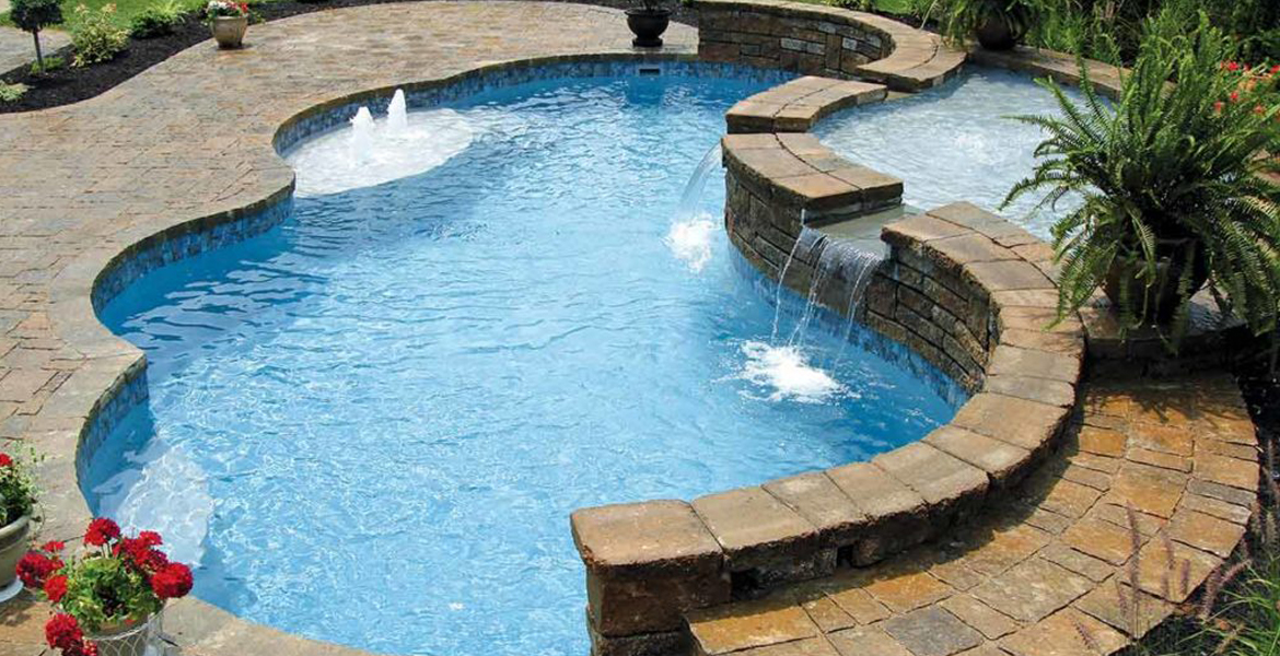 freeform fiberglass pool with splash deck